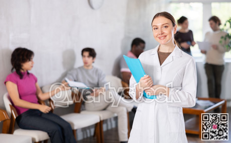 Female doctor in medical uniform posing in clinic reception