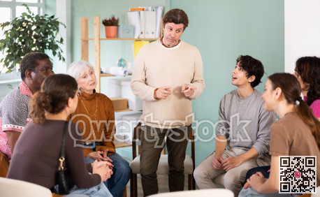 man performs in front of people who sit in a circle