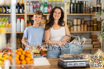Adolescence boy with mother choose consider snacks in shop