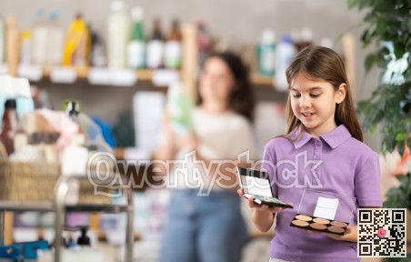 Girl chooses cosmetics in household chemicals store