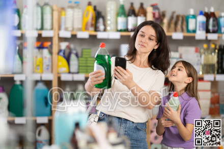 Mother and daughter checking expiration date of dishwashing liquid using smartphone in household supermarket
