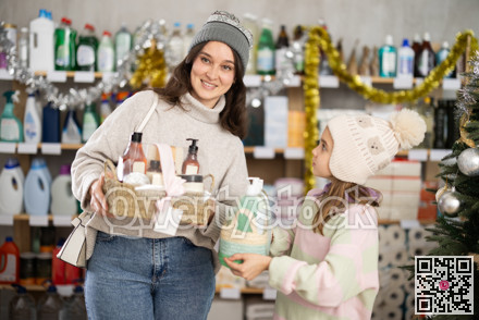 Mom and daughter shopping for Christmas presents together at home goods store