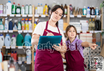 Woman seller and her daughter take inventory in store