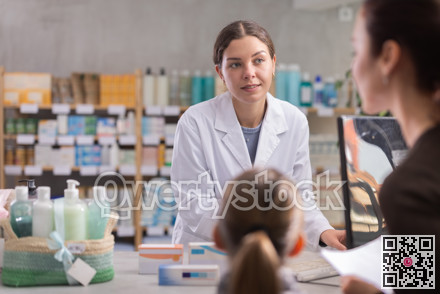Girl pharmacist near computer during family consulting