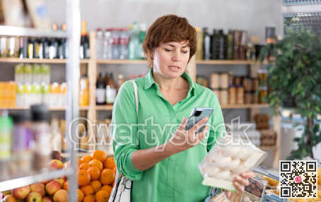 Adult woman scanning qr code of champignons