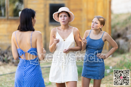 Three women arguing outside country house