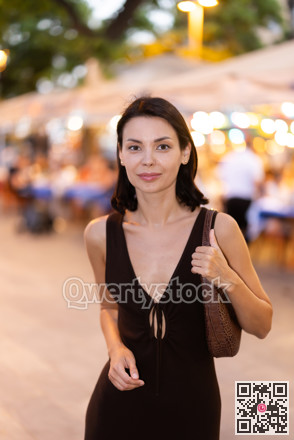 Young woman walking through urban street in Barcelona