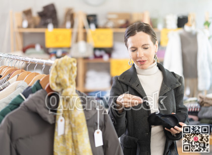 Middle-aged woman choosing heels in clothing store