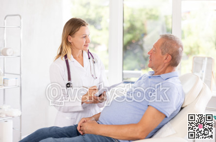 Female doctor with document folder talking to senior male patient