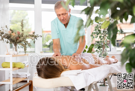 male masseur giving massage to female patient