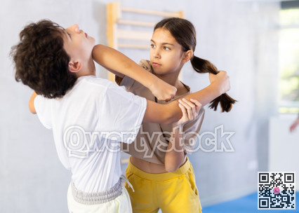 Boy and girl practicing self-defense techniques