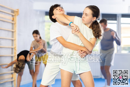 Boy and girl practicing self-defense techniques