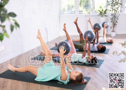 Kids doing pilates with softball