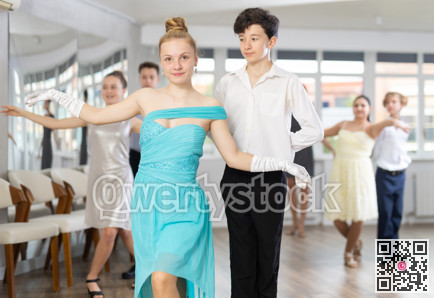 Pair dances - girls and guys in festive attire dance tango or samba in studio
