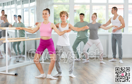 Ballet training for teenagers in a ballet studio under the guidance of choreographer