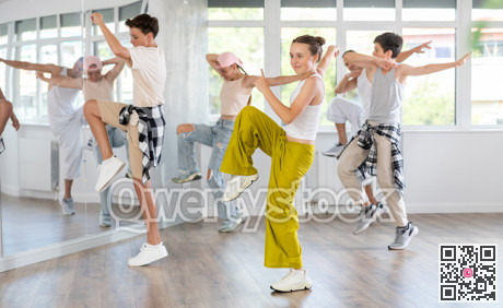 Teenage girl practicing hip hop reject step in training hall