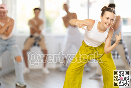 Teenage girl dancing hip hop in group