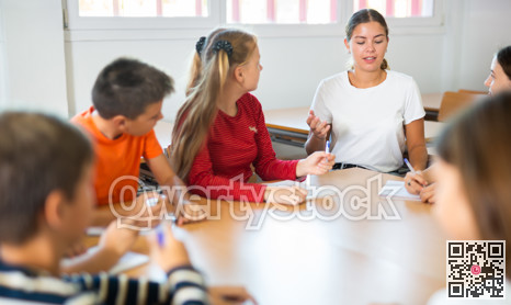 Group of girls and boys studying in school
