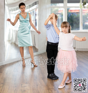 Tween dancers, girl and boy practicing waltz in dance studio
