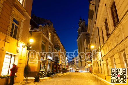 Night view of illuminated Pilies street in Old Town of Vilnius, Lithuania