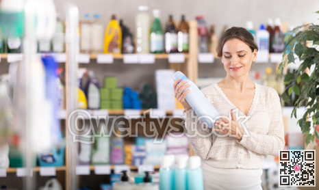 Young woman choosing laundry detergent in department store
