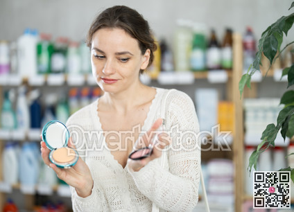 Woman purchases household chemicals in store and chooses eye shadow pallet