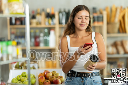 Young woman scanning qr code of beans
