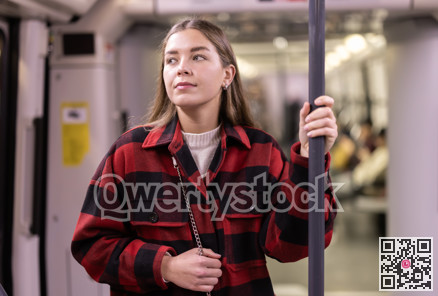 Girl is standing in subway car, getting to work