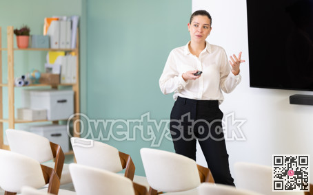 Girl teacher speaker with remote control during lecture