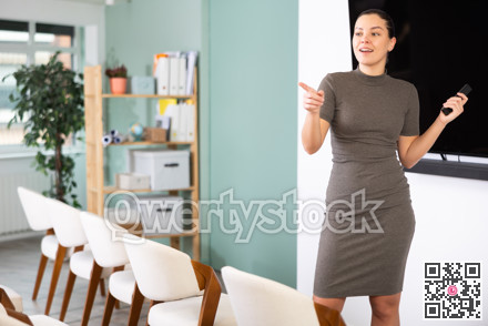 Girl teacher speaker with remote control during lecture