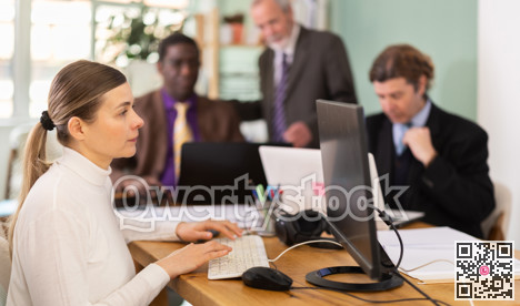 Middle aged woman working in a team in an office