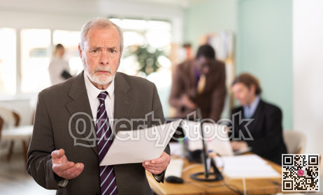 Thoughtful or frustrated mature man employee with documents