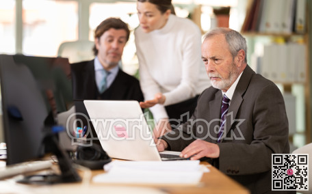 Mature man working in a team in an office