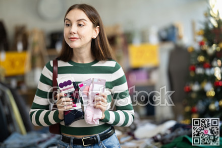 Young woman chooses socks in clothing store