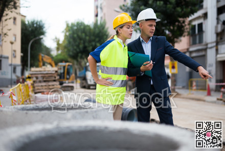 Civil engineers checking work process in construction site