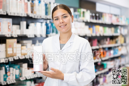Female pharmacist offers cosmetics products while standing in the trading floor of pharmacy