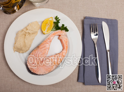 Top view of seared salmon and hummus