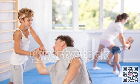 Father and son training self-defense techniques