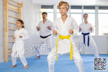 Family with children training karate techniques