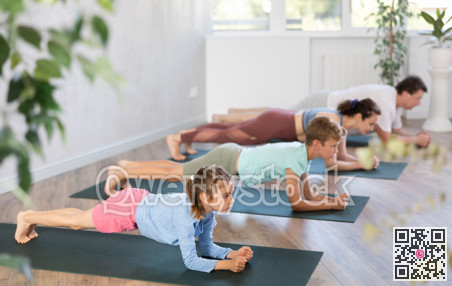 Family with two children doing pilates in studio