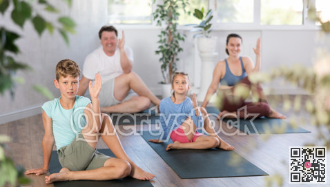 Boy performs asana lord of fish for yoga class with his family