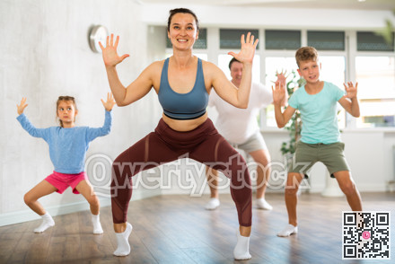 Family with two children dancing in studio