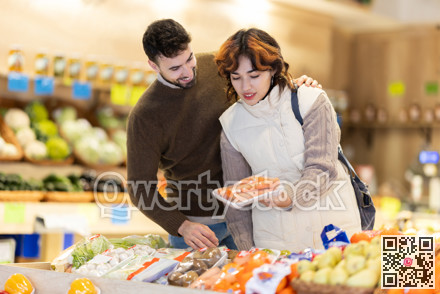 Married couple choose ripe carrot together at grocery supermarket