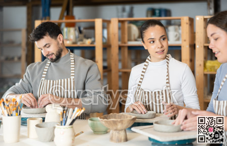 Three pottery workshop workers sculpt from clay, form final product