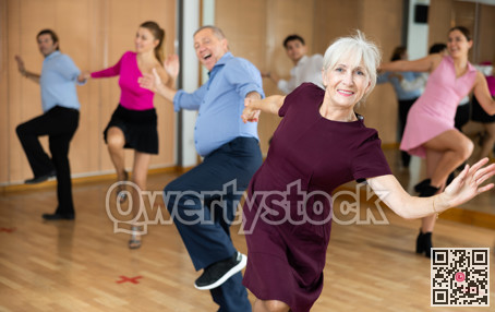 Older woman enjoying active dancing in dance studio
