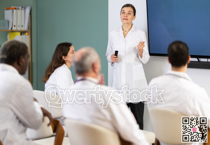 Woman doctor with remote controller speaks to audience of listeners