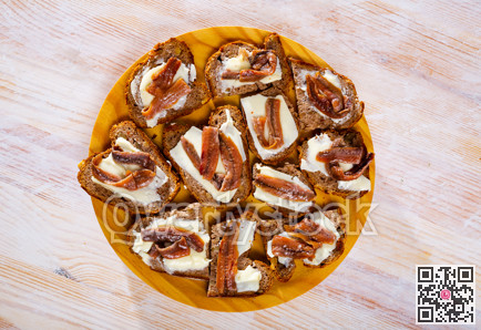 Black bread canapes with anchovies