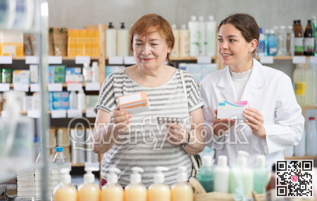Woman choosing pills with help from pharmacist