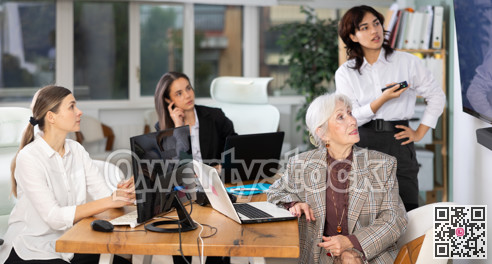 In study room, female business colleagues listens to lecture, look to presentation.