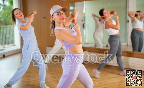 Positive people practicing vigorous lindy hop movements in dance class